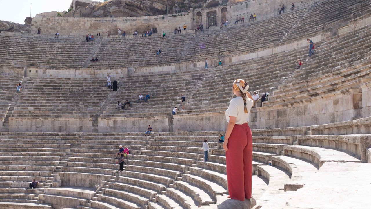 Roman theater in Amman with a person standing on a bench