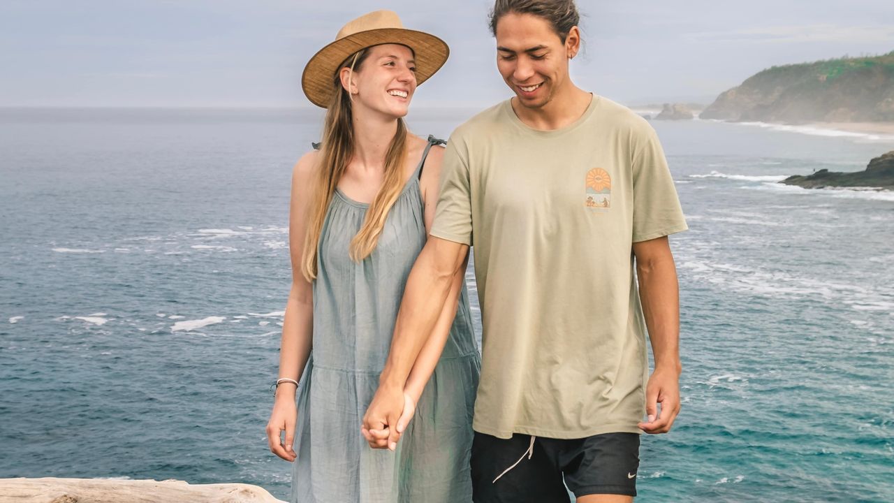 Mark and Lison on a cliff with the ocean in the background