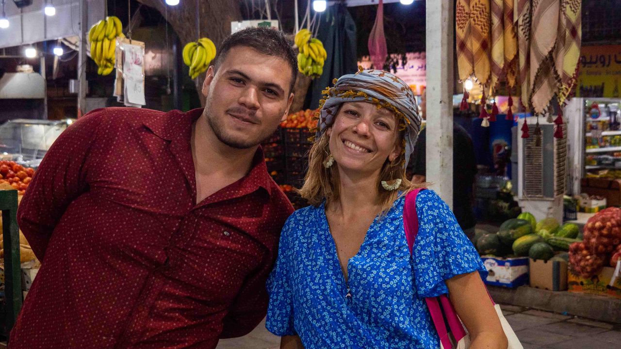 Two person posing in a market