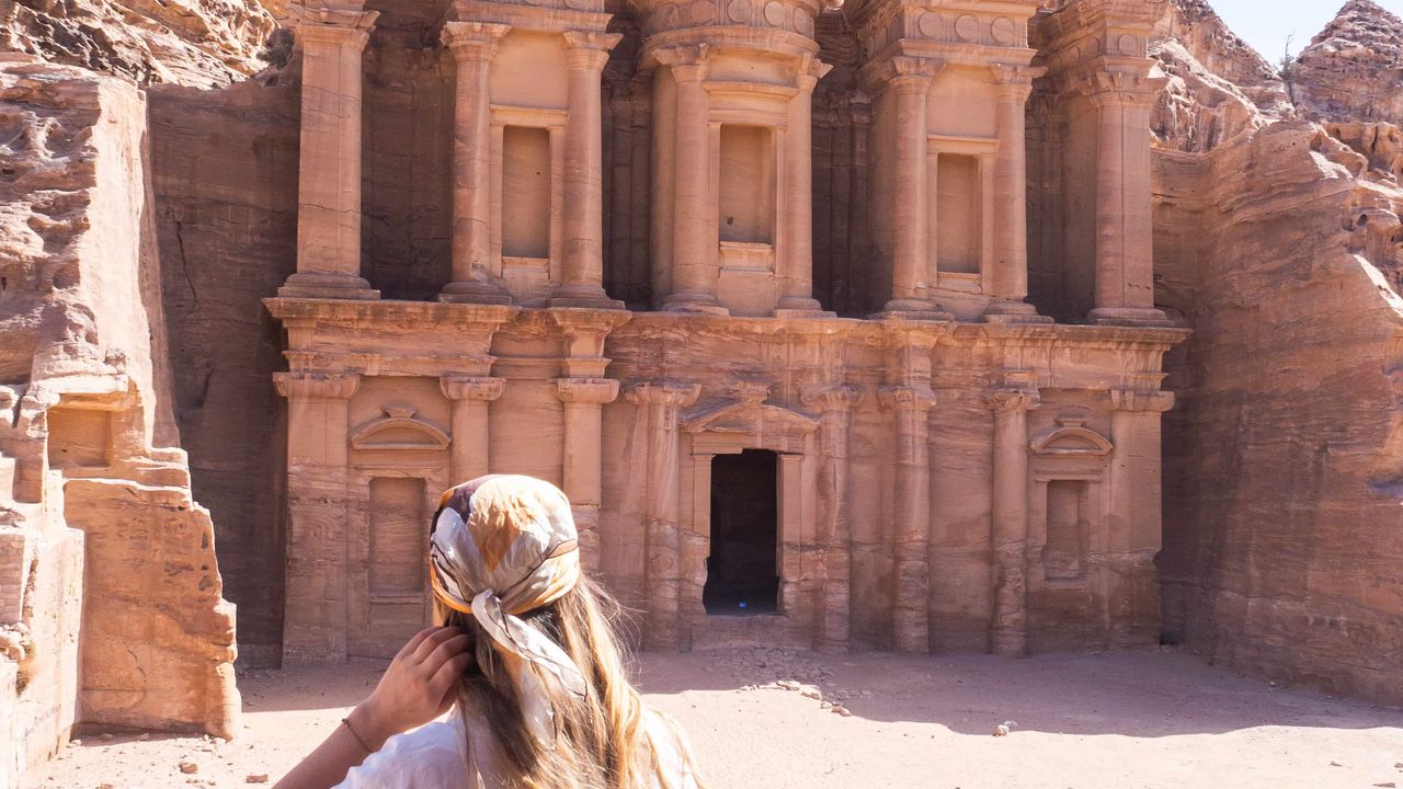 A woman looking at the monastry in Petra