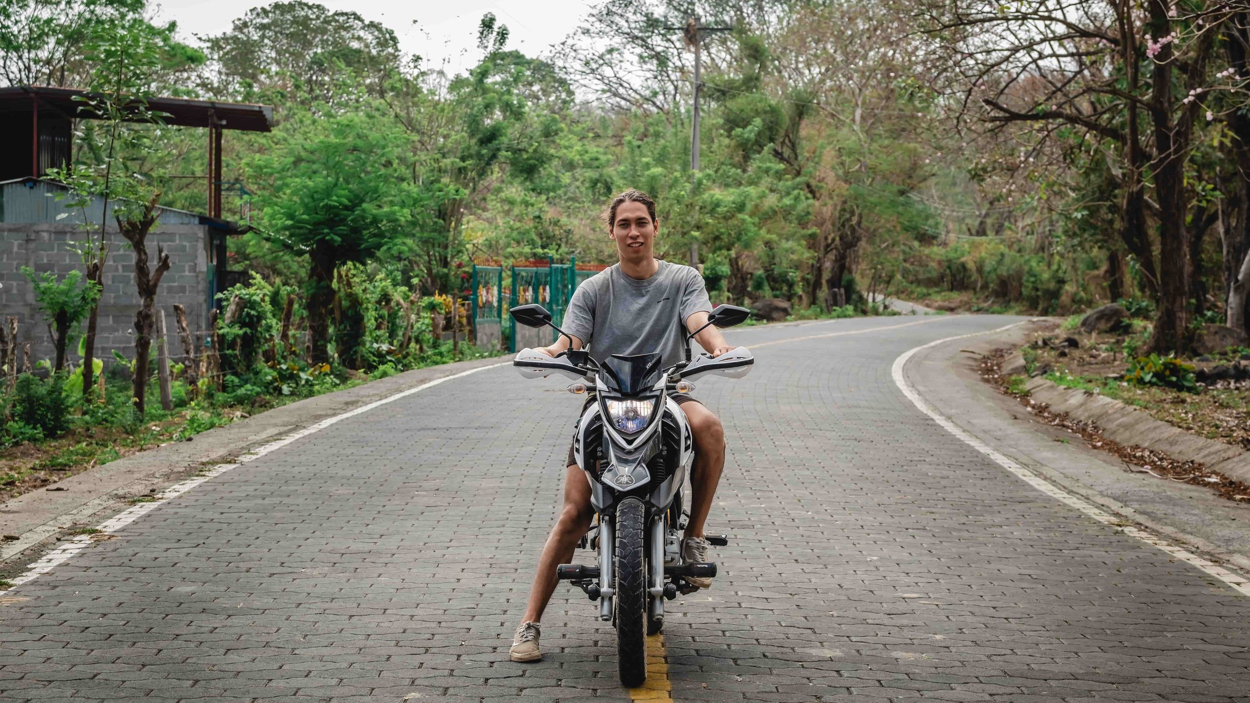 A man sitting on a motorbike on the road