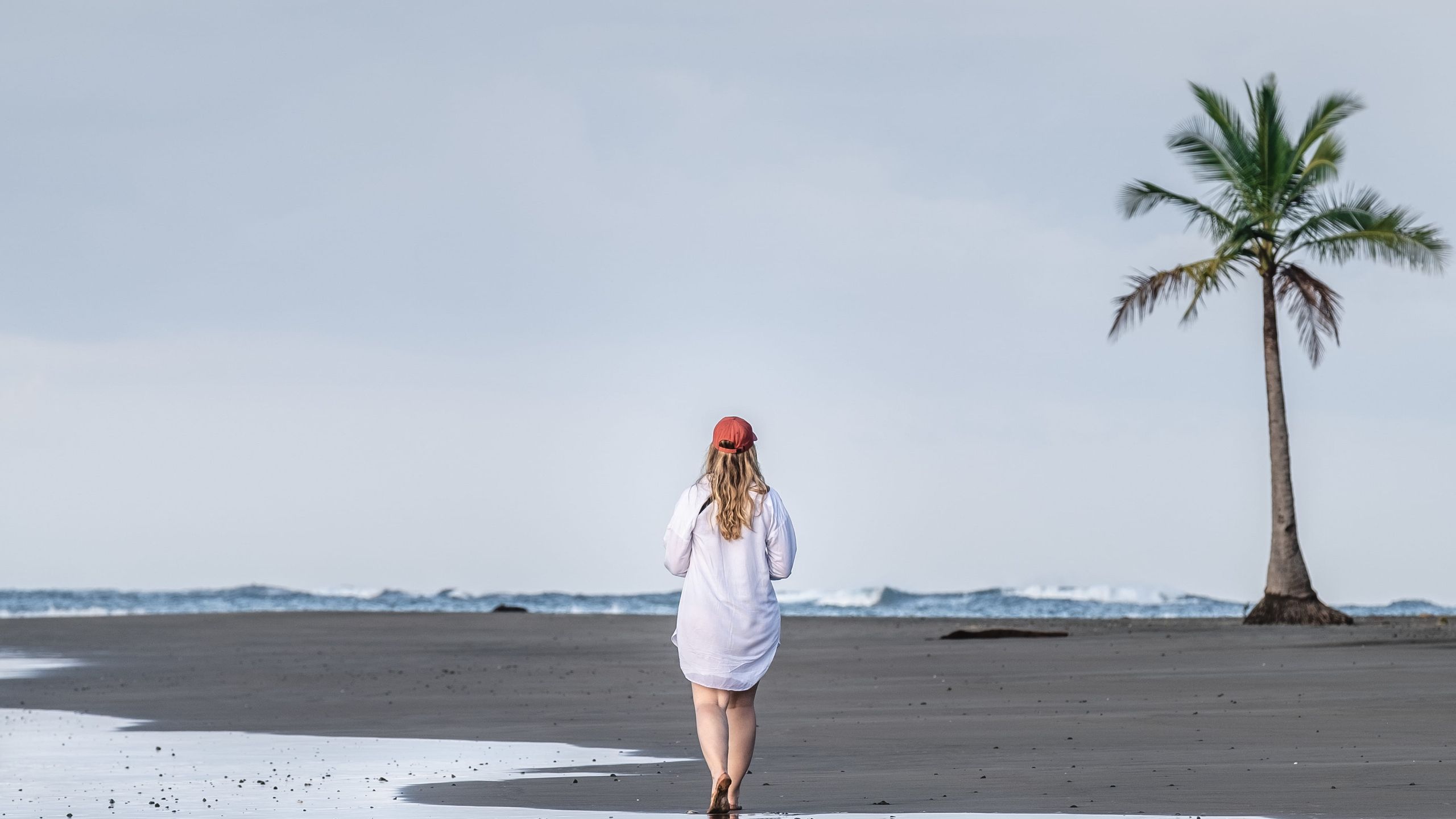 Lison, walking on the beach in the calm early morning with beautiful sunrise colors.